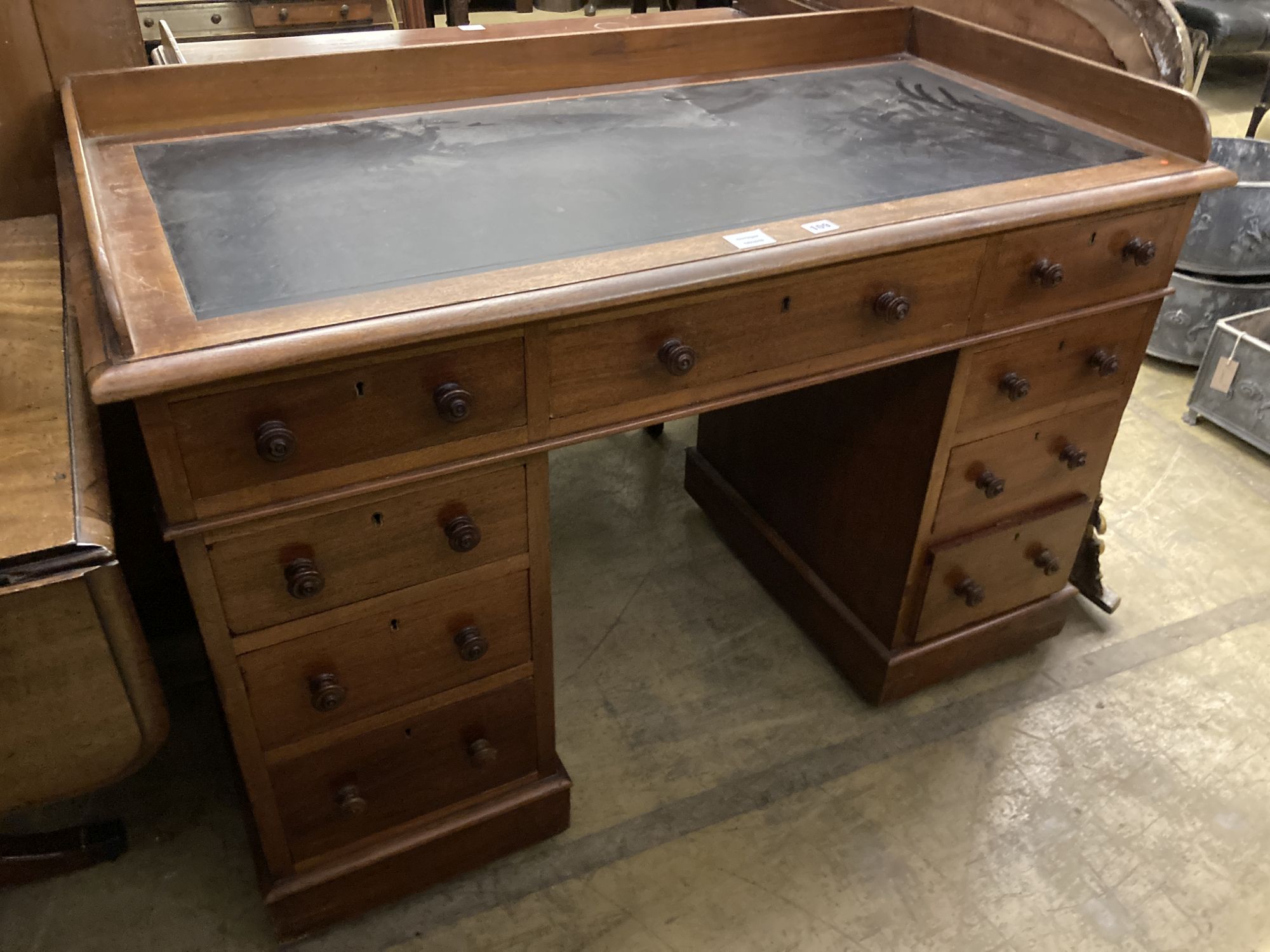 A Victorian mahogany pedestal desk, with a three quarter gallery top, width 122cm, depth 60cm, height 83cm